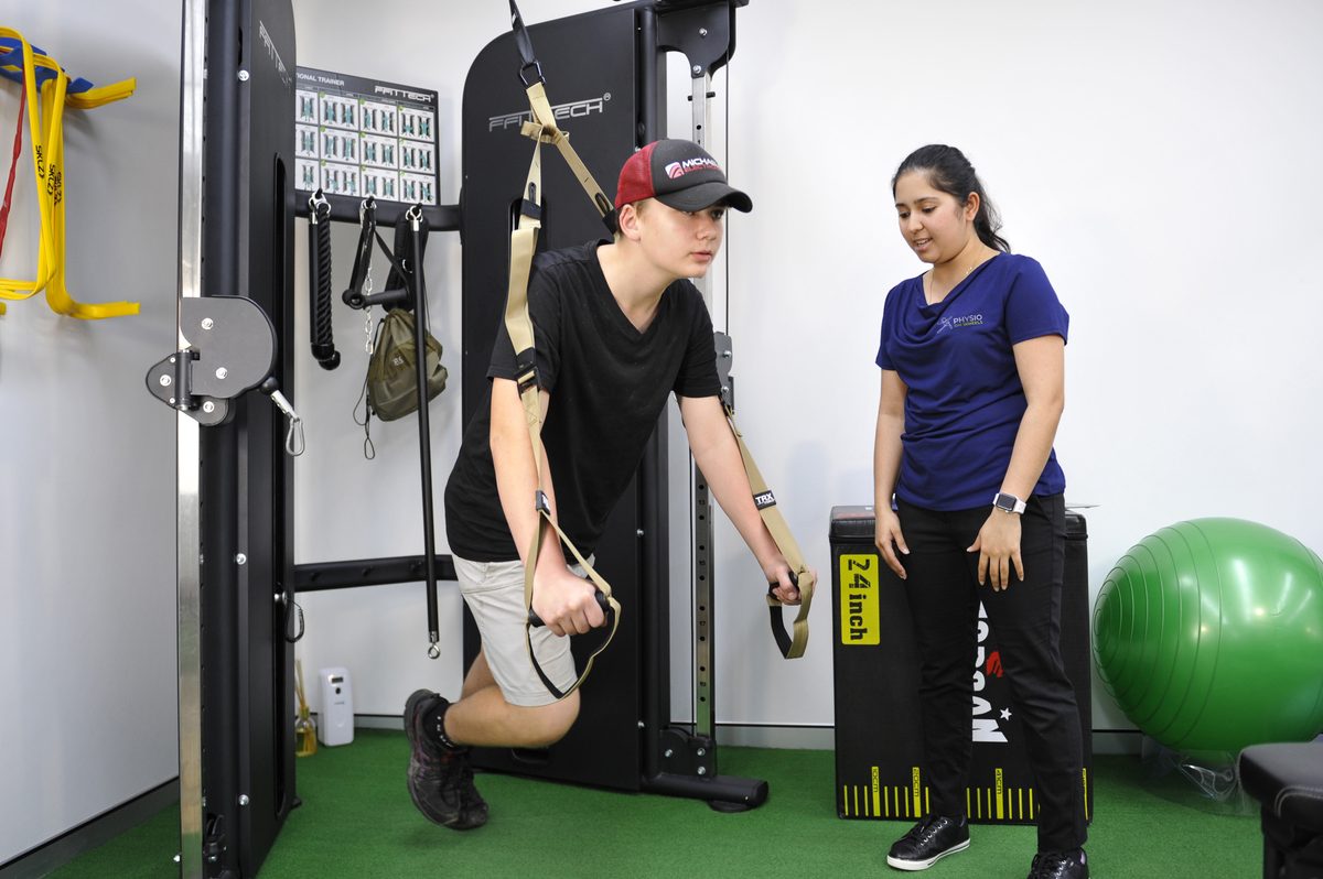 Physiotherapist supporting a client during functional neurological rehabilitation