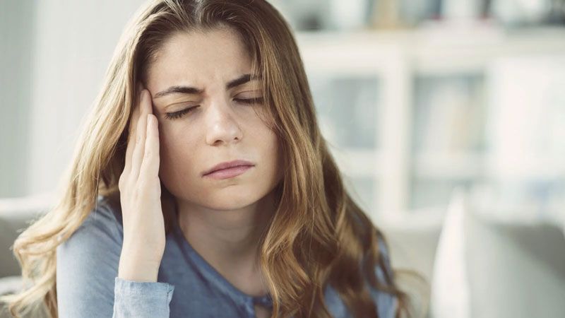 A patient receiving an assessment for headache and neck pain